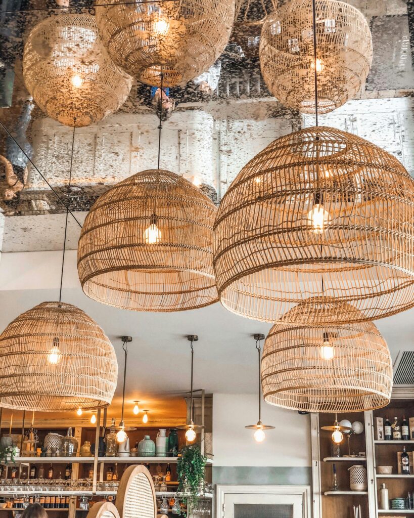 Stylish wicker pendant lights enhancing the ambiance of a modern French café in Alfortville, France.